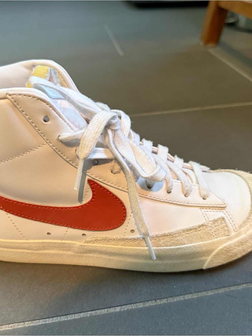 Nike Women’s White High-Top Sneakers with Orange Swoosh